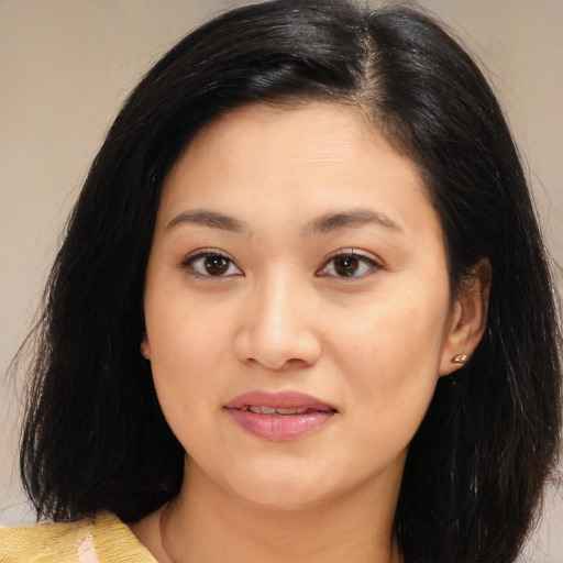 Joyful latino young-adult female with medium  black hair and brown eyes