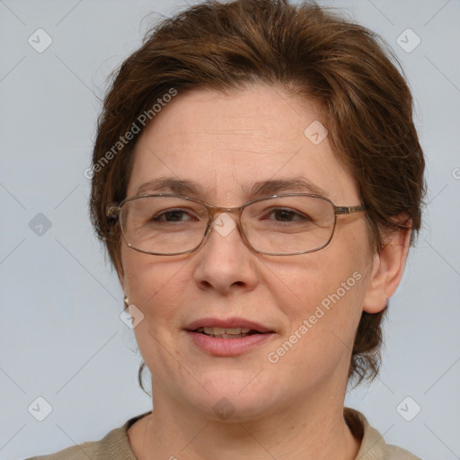 Joyful white adult female with medium  brown hair and blue eyes