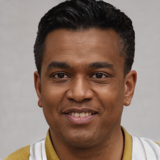 Joyful latino young-adult male with short  black hair and brown eyes