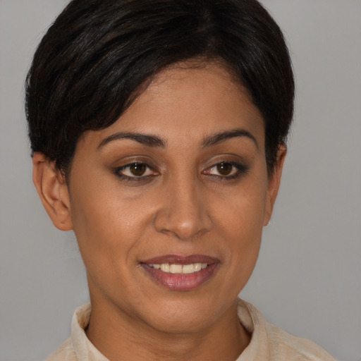 Joyful latino young-adult female with short  brown hair and brown eyes