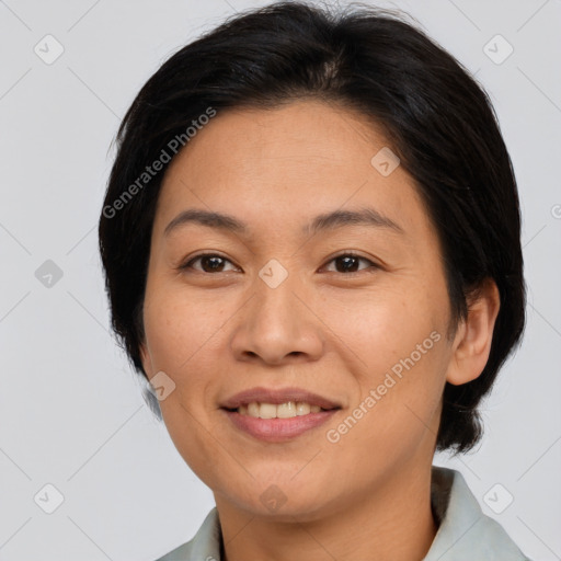 Joyful asian adult female with medium  brown hair and brown eyes