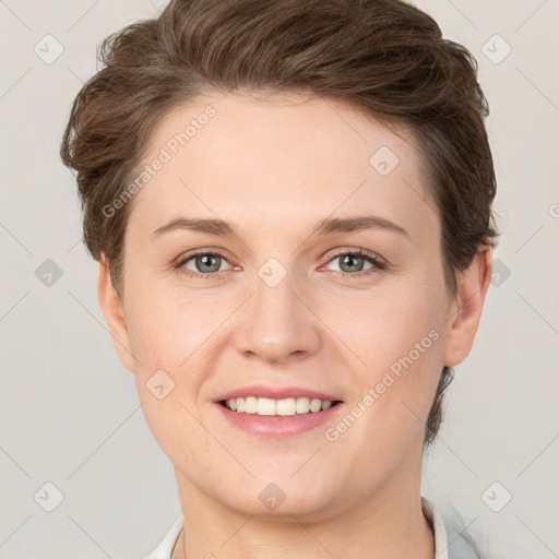 Joyful white young-adult female with short  brown hair and grey eyes