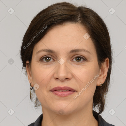 Joyful white adult female with medium  brown hair and grey eyes