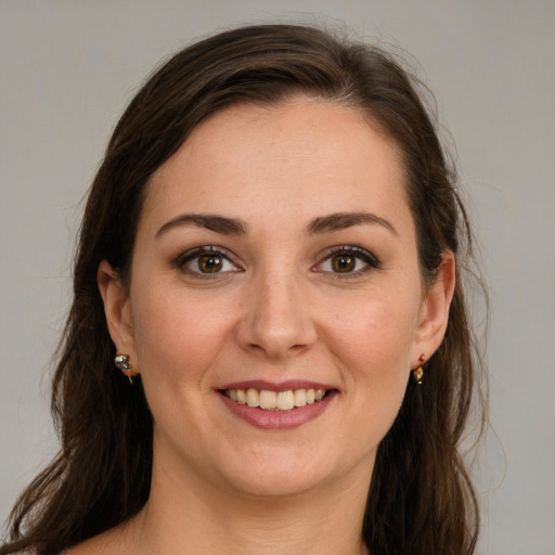 Joyful white young-adult female with long  brown hair and brown eyes