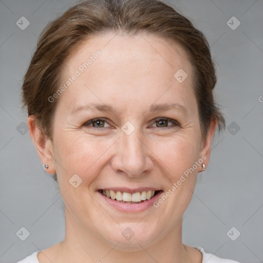 Joyful white adult female with short  brown hair and grey eyes