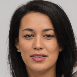 Joyful asian young-adult female with long  brown hair and brown eyes