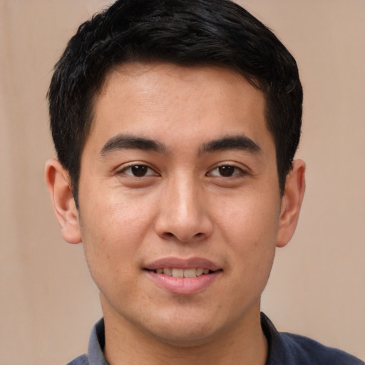 Joyful white young-adult male with short  black hair and brown eyes