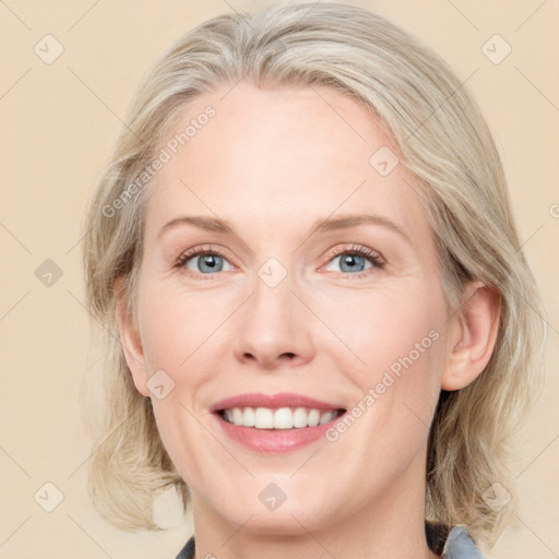 Joyful white adult female with medium  brown hair and blue eyes