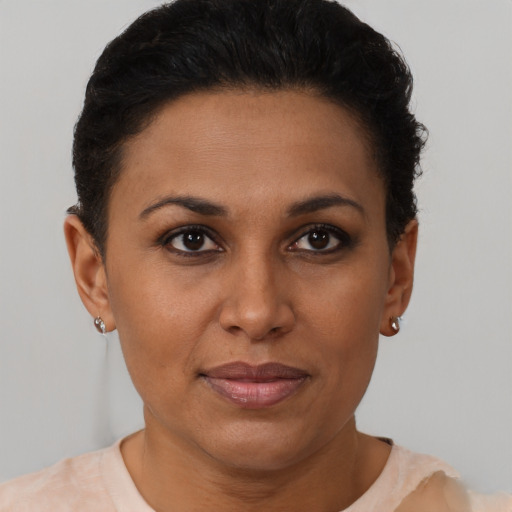 Joyful black young-adult female with short  brown hair and brown eyes