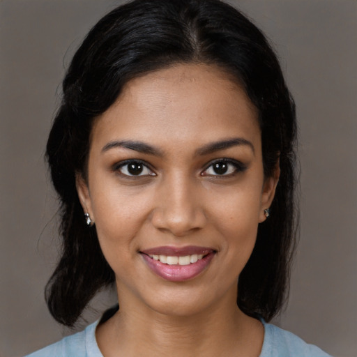 Joyful black young-adult female with medium  black hair and brown eyes
