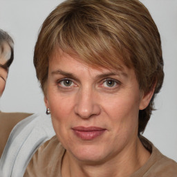 Joyful white adult female with medium  brown hair and blue eyes