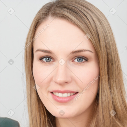 Joyful white young-adult female with long  brown hair and green eyes