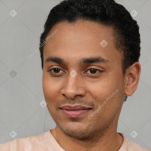 Joyful latino young-adult male with short  black hair and brown eyes