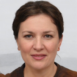 Joyful white adult female with short  brown hair and grey eyes