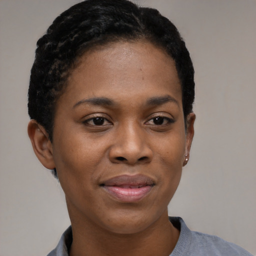 Joyful black young-adult female with short  black hair and brown eyes