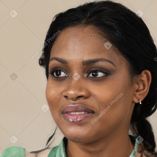 Joyful black young-adult female with long  black hair and brown eyes