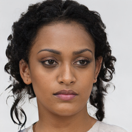 Neutral black young-adult female with medium  brown hair and brown eyes