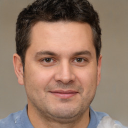 Joyful white adult male with short  brown hair and brown eyes