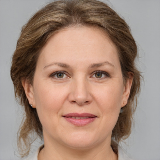 Joyful white adult female with medium  brown hair and brown eyes