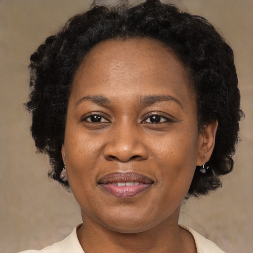 Joyful black adult female with short  brown hair and brown eyes