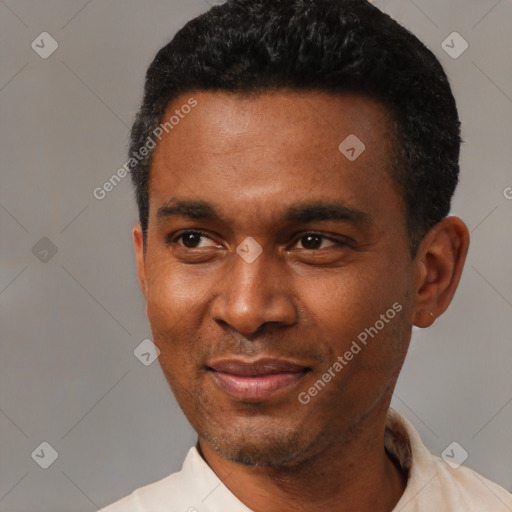 Joyful latino young-adult male with short  black hair and brown eyes