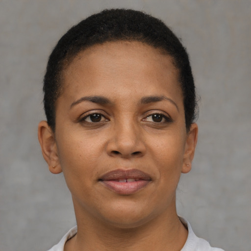 Joyful black young-adult female with short  brown hair and brown eyes