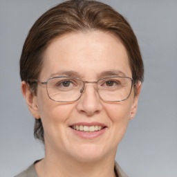 Joyful white adult female with medium  brown hair and grey eyes