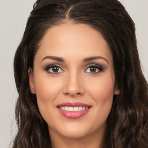 Joyful white young-adult female with long  brown hair and brown eyes