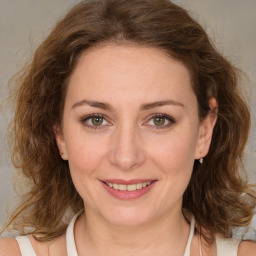 Joyful white young-adult female with medium  brown hair and green eyes