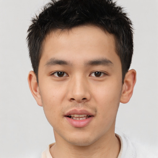 Joyful asian young-adult male with short  brown hair and brown eyes