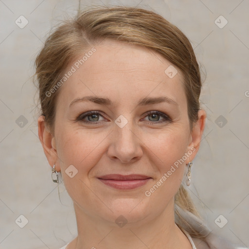 Joyful white adult female with medium  brown hair and grey eyes