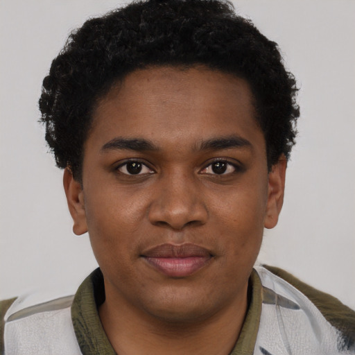 Joyful black young-adult male with short  black hair and brown eyes