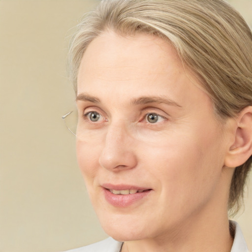 Joyful white adult female with medium  brown hair and blue eyes