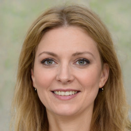 Joyful white young-adult female with long  brown hair and green eyes