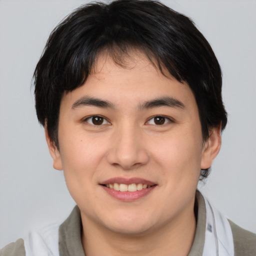 Joyful asian young-adult male with medium  brown hair and brown eyes