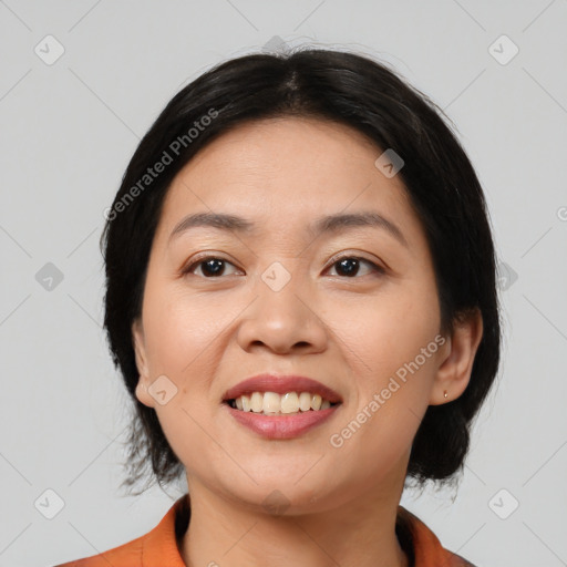 Joyful asian young-adult female with medium  black hair and brown eyes