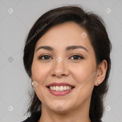 Joyful white adult female with medium  brown hair and brown eyes