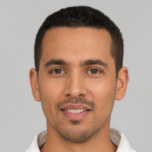 Joyful white young-adult male with short  black hair and brown eyes