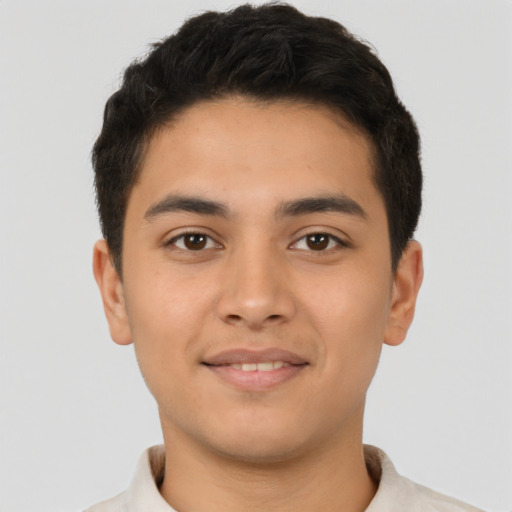 Joyful latino young-adult male with short  brown hair and brown eyes