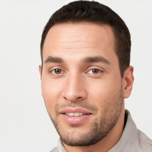 Joyful white young-adult male with short  brown hair and brown eyes