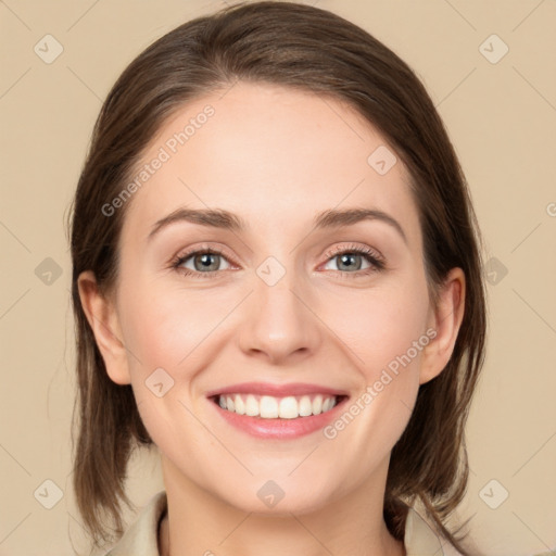 Joyful white young-adult female with medium  brown hair and green eyes