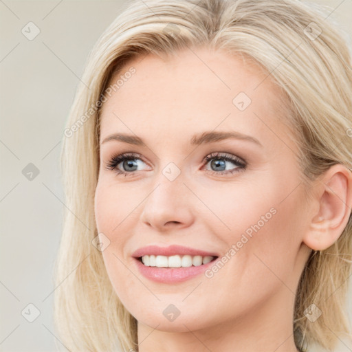 Joyful white young-adult female with long  brown hair and blue eyes