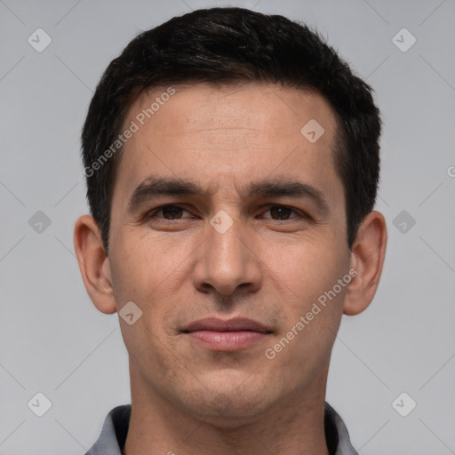 Joyful white young-adult male with short  black hair and brown eyes