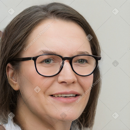 Joyful white adult female with long  brown hair and blue eyes