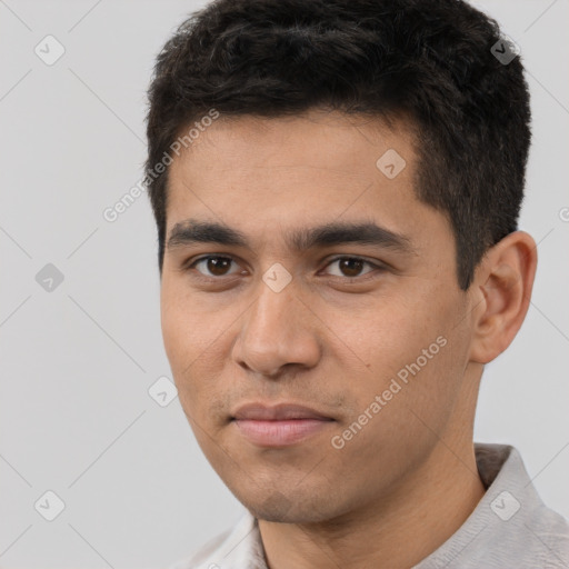 Joyful white young-adult male with short  black hair and brown eyes