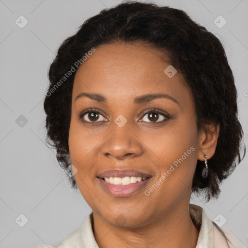 Joyful black adult female with medium  brown hair and brown eyes