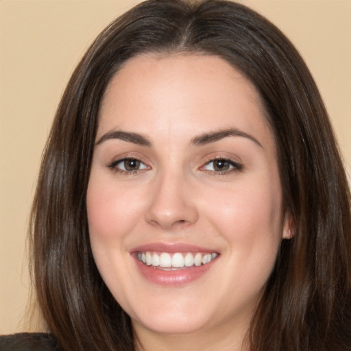 Joyful white young-adult female with long  brown hair and brown eyes