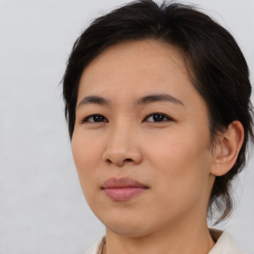 Joyful asian young-adult female with medium  brown hair and brown eyes