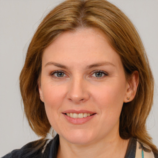 Joyful white young-adult female with medium  brown hair and blue eyes