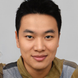 Joyful asian young-adult male with short  brown hair and brown eyes